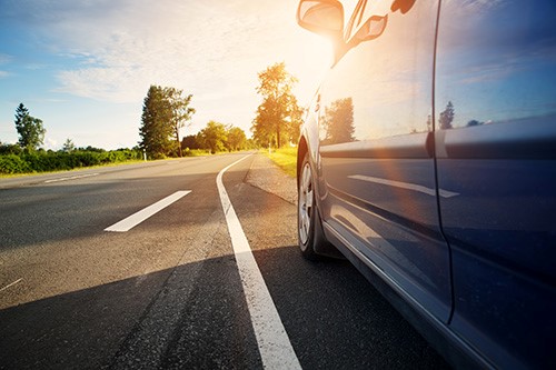 Car on asphalt road in summer
